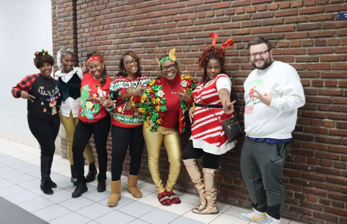  Staff members wearing their crazy Christmas sweater for Spirit Week.